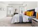 Bright main bedroom featuring neutral carpet, tray ceilings, and stylish, colorful decor at 3103 Woodland Park Rd, Durham, NC 27703