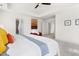 Bright main bedroom featuring neutral carpet, tray ceilings, and art at 3103 Woodland Park Rd, Durham, NC 27703