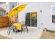 Cozy patio with dining set and a bright yellow umbrella for outdoor entertaining at 3103 Woodland Park Rd, Durham, NC 27703