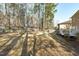 Expansive fenced backyard with mature trees and natural landscaping at 315 Barthel Dr, Cary, NC 27513