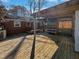 A covered deck offers an outdoor living space with wood flooring and open views at 317 Gary St, Raleigh, NC 27606