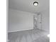 An open bedroom features neutral walls and carpet, awaiting personalization and decor at 317 Gary St, Raleigh, NC 27606