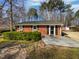 Brick single-story home with a trimmed front hedge, shutters, and a light-colored front porch at 317 Gary St, Raleigh, NC 27606