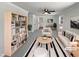 Bright, virtually staged living room with contemporary furniture, a ceiling fan, and a large bookshelf at 317 Gary St, Raleigh, NC 27606