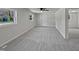 The expansive living room has three windows allowing for an abundance of natural light and neutral carpeting at 317 Gary St, Raleigh, NC 27606