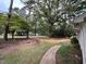 A large front yard with mature trees surrounds this well-maintained property at 3329 Bearskin Ct, Raleigh, NC 27606