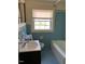 Bathroom featuring a tub, vanity, and a window for natural light at 333 Leasburg Rd, Roxboro, NC 27573