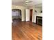 Living room featuring wood flooring, a fireplace, and an archway to the dining room at 333 Leasburg Rd, Roxboro, NC 27573