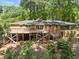 Brick home with a large wooden deck overlooking the backyard at 3605 Octavia St, Raleigh, NC 27606