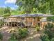Brick home with a large wooden deck overlooking the backyard at 3605 Octavia St, Raleigh, NC 27606