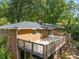 Brick home with a large wooden deck overlooking the backyard at 3605 Octavia St, Raleigh, NC 27606