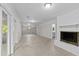 Spacious finished basement with a white painted brick fireplace and sliding glass doors at 3605 Octavia St, Raleigh, NC 27606