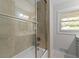 Bathroom with updated tile, glass shower door, and modern fixtures at 3605 Octavia St, Raleigh, NC 27606