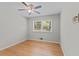 Bright, airy bedroom with hardwood floors, ceiling fan, and a large window offering natural light at 3605 Octavia St, Raleigh, NC 27606