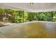 Spacious carport area with durable concrete flooring and overhead lighting at 3605 Octavia St, Raleigh, NC 27606