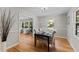 Charming dining room featuring hardwood floors, natural light, and a view into the adjacent living space at 3605 Octavia St, Raleigh, NC 27606