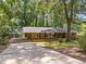 Exterior shot of a one-story brick home with a carport and a long driveway at 3605 Octavia St, Raleigh, NC 27606