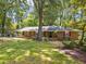 Beautiful brick home with mature trees and a lush green lawn at 3605 Octavia St, Raleigh, NC 27606