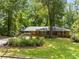 Charming single-story brick home with a well-manicured lawn and a covered carport at 3605 Octavia St, Raleigh, NC 27606