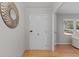 Hallway featuring hardwood floors and a decorative mirror for added elegance at 3605 Octavia St, Raleigh, NC 27606