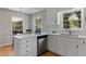 Modern kitchen with a white island, countertops, stainless steel appliances, and natural light at 3605 Octavia St, Raleigh, NC 27606