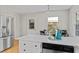 Modern kitchen with a white island and breakfast nook featuring natural light and stainless steel appliances at 3605 Octavia St, Raleigh, NC 27606