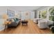 Cozy living room with hardwood floors, a gray couch, and white armchairs, providing a comfortable space at 3605 Octavia St, Raleigh, NC 27606