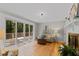 Bright living room with hardwood floors, fireplace, and access to outdoor deck at 3605 Octavia St, Raleigh, NC 27606