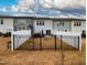 Back view of townhomes featuring fenced yard at 372 White Oak Ridge Dr, Garner, NC 27529