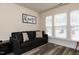 Comfortable bedroom with hardwood floors, bright windows, and a sofa bed at 372 White Oak Ridge Dr, Garner, NC 27529