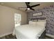 Stylized bedroom featuring a decorative wall, fan, and a bright window at 372 White Oak Ridge Dr, Garner, NC 27529