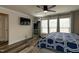 Bright bedroom with a ceiling fan, TV, large bed, and ample natural light from the windows at 372 White Oak Ridge Dr, Garner, NC 27529