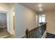 Upstairs hallway featuring three doors and natural light at 372 White Oak Ridge Dr, Garner, NC 27529