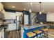Modern kitchen features stainless steel appliances, white cabinets, and a large island with pendant lighting at 372 White Oak Ridge Dr, Garner, NC 27529
