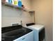 Modern laundry room featuring side by side washer and dryer with shelving at 372 White Oak Ridge Dr, Garner, NC 27529