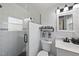 Bathroom featuring a glass enclosed tile shower, tiled floors, and modern lighting at 401 Fletcher Dr, Raleigh, NC 27603