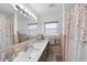 Bathroom featuring a bathtub with pink tile, an updated sink and countertop with decor accents at 401 Fletcher Dr, Raleigh, NC 27603