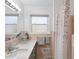 Bathroom featuring a bathtub with pink tile, an updated sink and countertop with decor accents at 401 Fletcher Dr, Raleigh, NC 27603