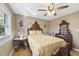 Bedroom with an ornate wooden bed frame, light-colored walls, and light-colored hardwood flooring at 401 Fletcher Dr, Raleigh, NC 27603