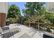 Back deck featuring chairs, a BBQ and lush green trees in the background at 401 Fletcher Dr, Raleigh, NC 27603