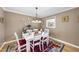 Charming dining area with white table, hardwood floors, and decorative wall plates at 401 Fletcher Dr, Raleigh, NC 27603