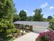 Charming brick home featuring a well-manicured lawn, mature trees, and a two-car garage at 401 Fletcher Dr, Raleigh, NC 27603