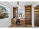 Inviting home office with built-in shelving, natural light, and hardwood flooring at 401 Fletcher Dr, Raleigh, NC 27603