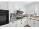 Beautiful kitchen featuring custom white cabinets, granite countertops, and stainless steel appliances at 401 Fletcher Dr, Raleigh, NC 27603