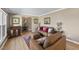 Spacious living room with hardwood floors, tan walls, and cozy seating arrangement at 401 Fletcher Dr, Raleigh, NC 27603