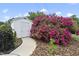 A well-maintained storage shed complemented by vibrant landscaping and a concrete pathway in the backyard at 401 Fletcher Dr, Raleigh, NC 27603