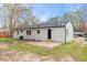 White brick home featuring an outdoor patio and a well-maintained backyard at 409 Avery St, Garner, NC 27529