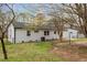 Large green backyard and a patio outside of this well-maintained white brick home at 409 Avery St, Garner, NC 27529