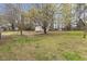 The backyard features mature trees and a storage shed, providing ample space at 409 Avery St, Garner, NC 27529