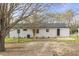 A spacious backyard with lush grass, a patio, and a well-maintained white brick home at 409 Avery St, Garner, NC 27529